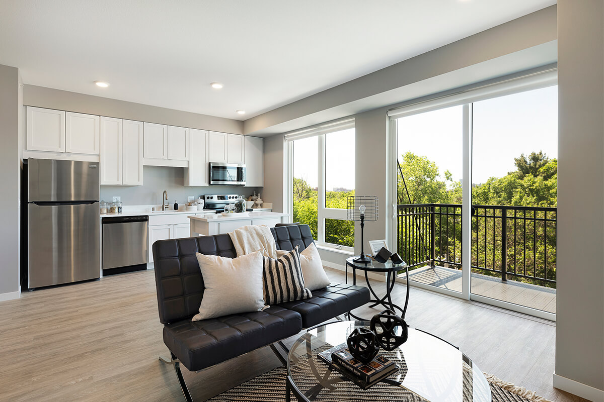  Open-plan living space with kitchen and balcony access.
